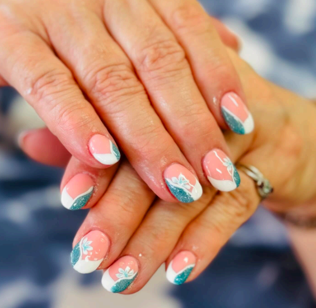Short coral and teal French tips with floral accents