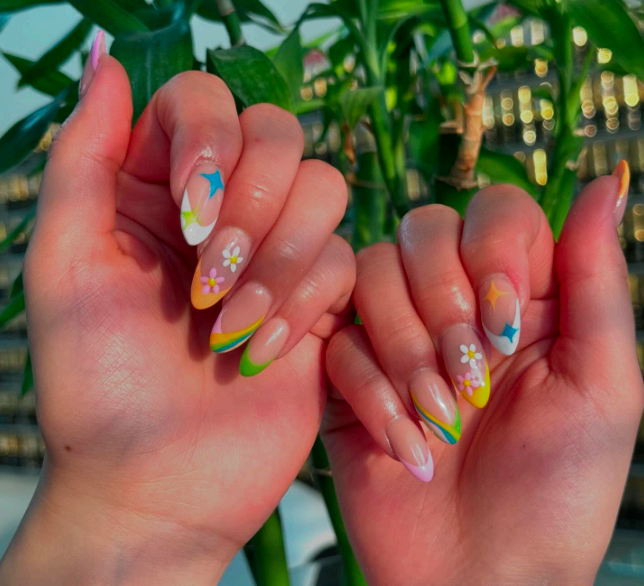 Multicolour pastel French tips with daisies and stars